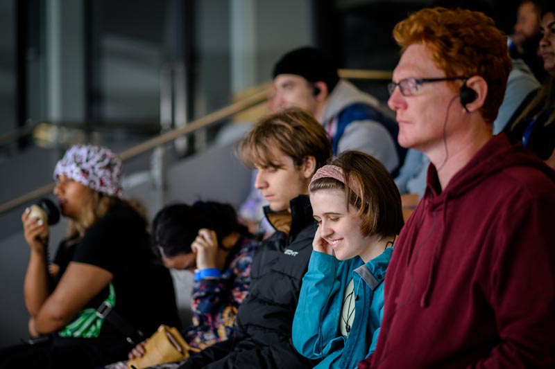 Audience member at Te Matatini smiling Audience member at Te Matatini smiling